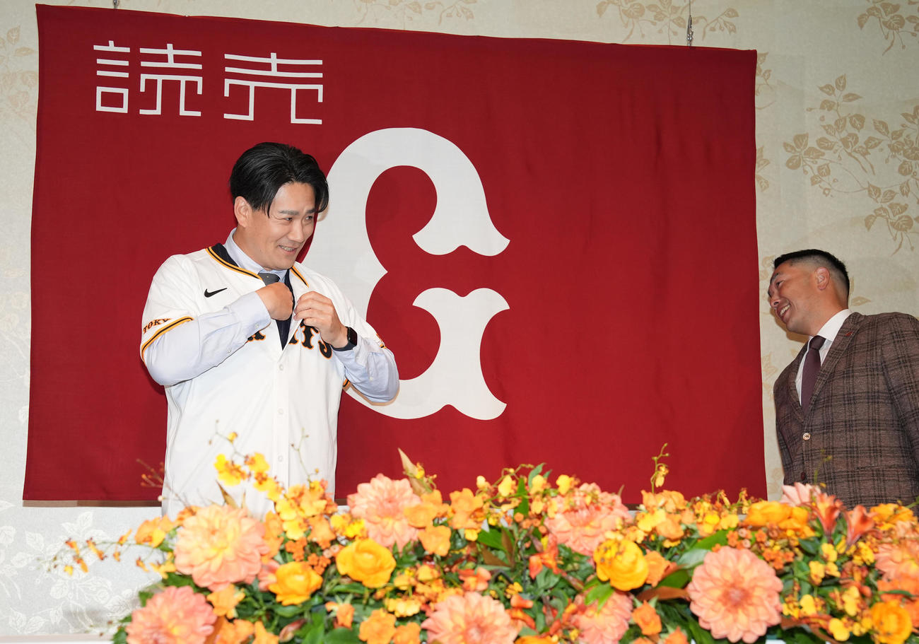 入団会見でユニホームを着る巨人田中将（左）と笑顔で見守る阿部監督（撮影・鈴木みどり）