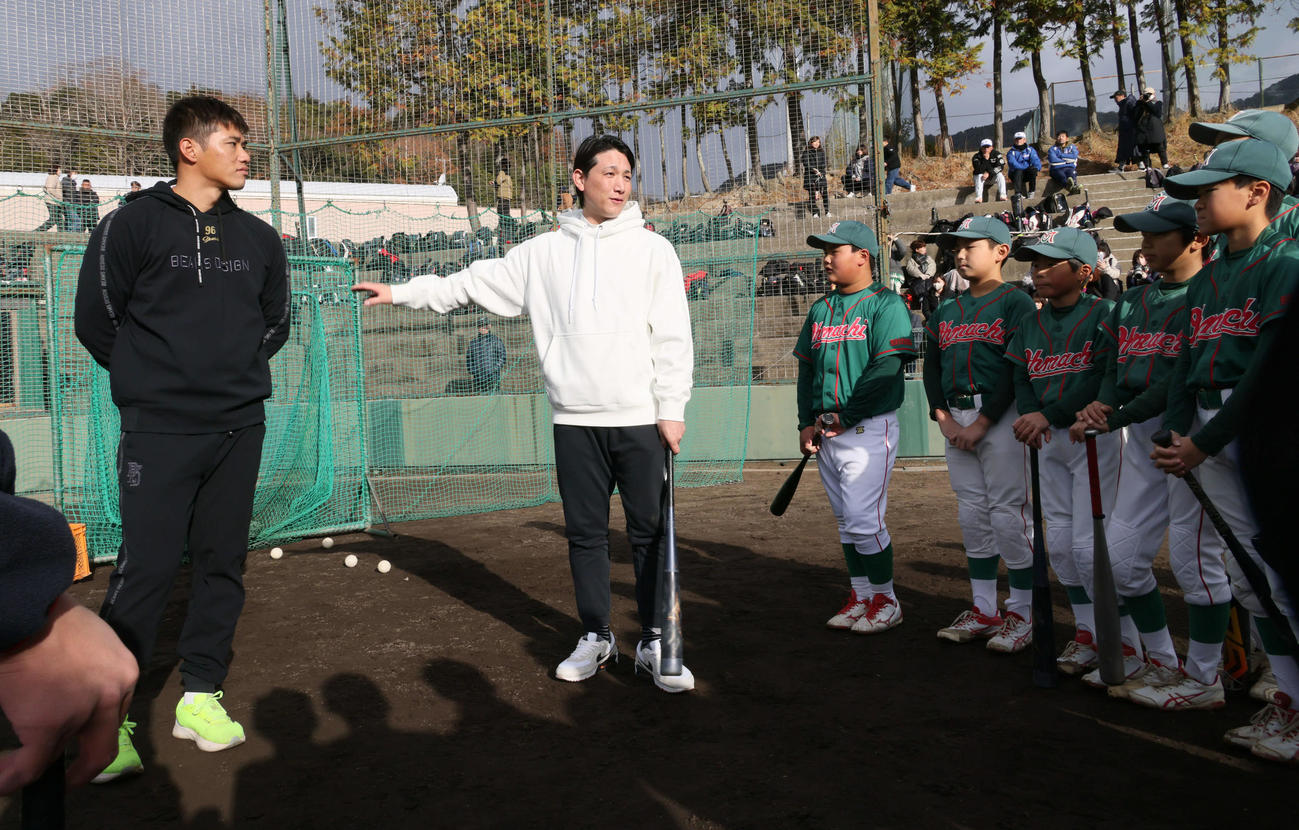 広陵高OB会野球教室で、小学生に打撃指導する巨人小林。左は広島中村奨（撮影・加藤孝規）