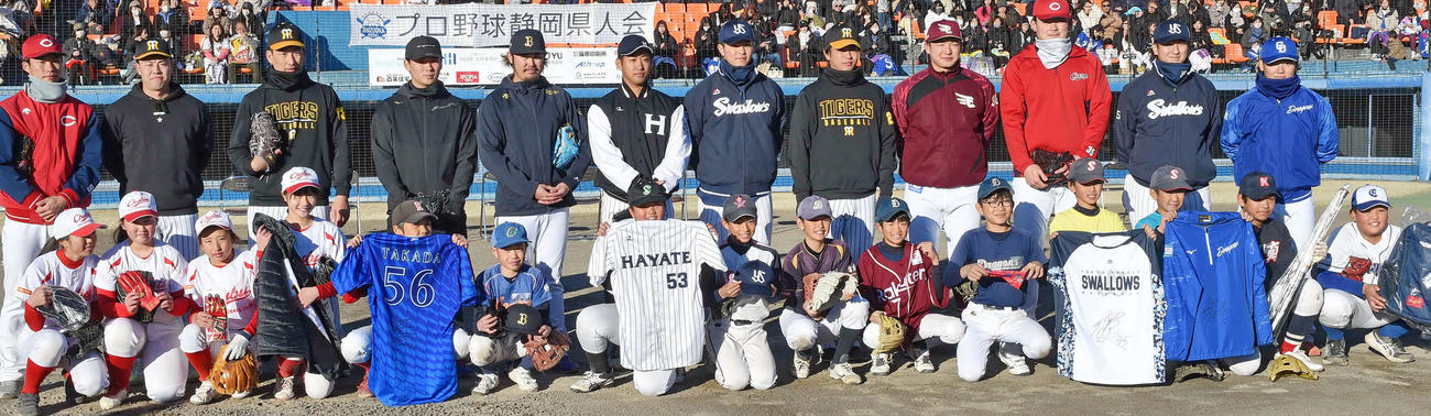 選手12人（後列）から記念品をもらう参加者たち　　