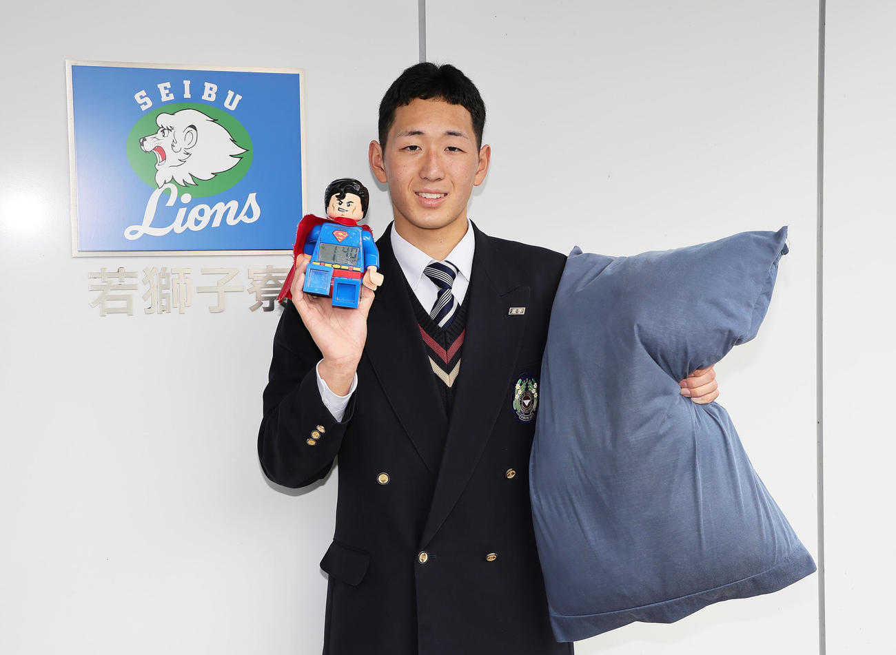 入寮した西武ドラフト5位福井工大福井高・篠原はお気に入りのスーパーマンの目覚まし時計とまくらを披露する（撮影・足立雅史）