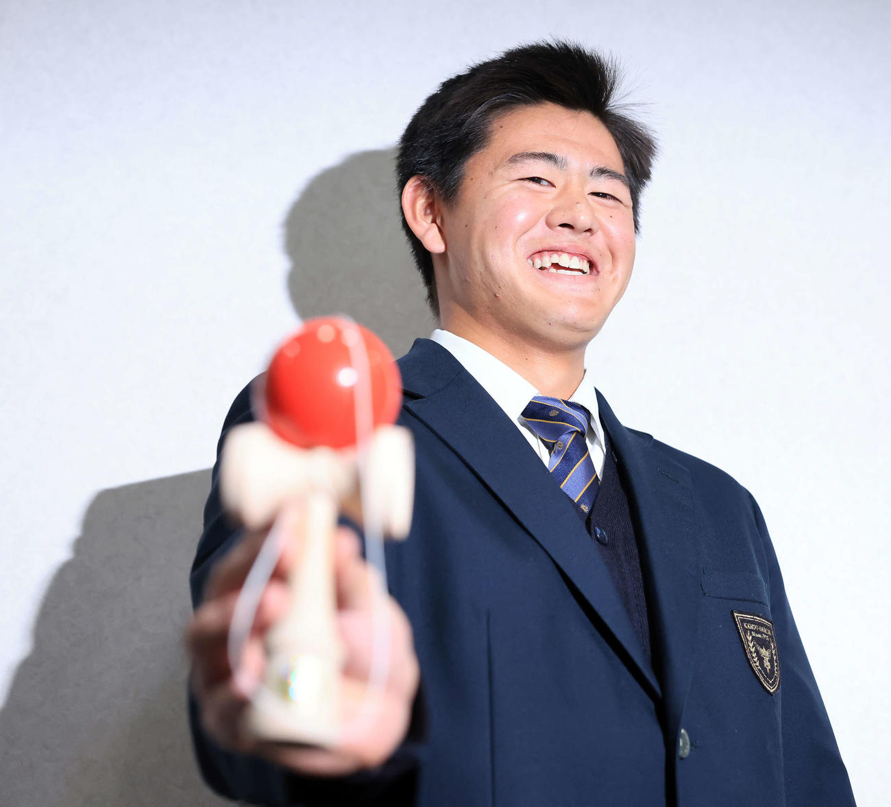 千葉ロッテマリーンズ寮に入寮した坂井は、持参したけん玉で技を披露し笑顔（撮影・浅見桂子）