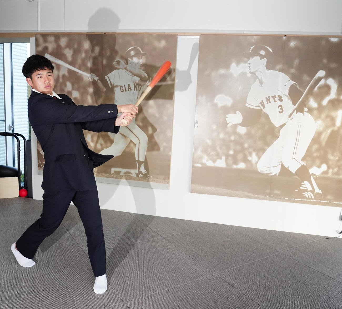入寮し、王、長嶋両氏の写真パネルが飾られるスイングルームでバットを振る巨人ドラフト1位の石塚（撮影・江口和貴）