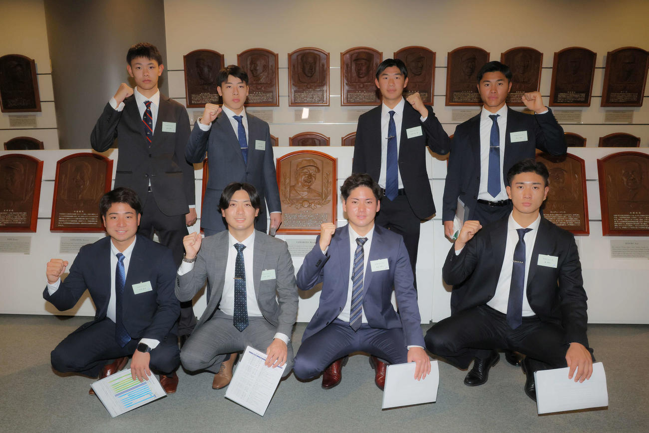 山本昌氏のレリーフの前で写真に納まる中日金丸（前列左から3人目）ら。手前左から石伊、吉田、1人おいて森駿、後方左から有馬、高橋幸、中村、井上（撮影・河田真司）