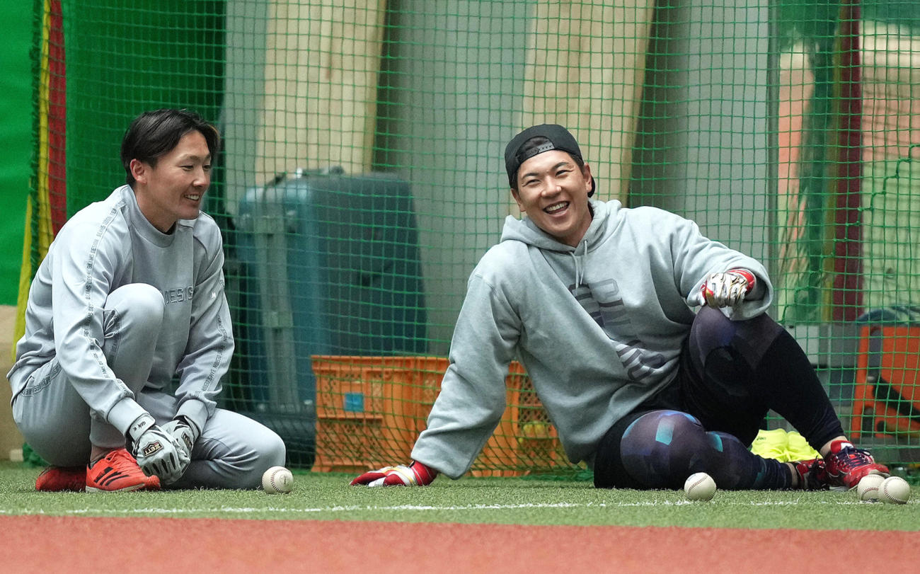 自主トレ中、西武炭谷（右）と談笑する源田（撮影・足立雅史）