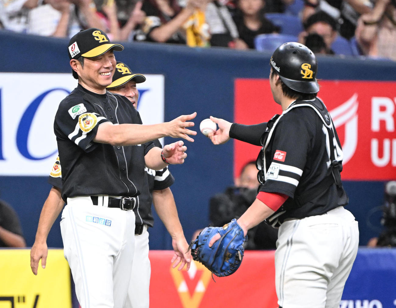 024年9月23日、リーグ優勝を果たし甲斐（右）からウイニングボールを受け取るソフトバンク小久保監督