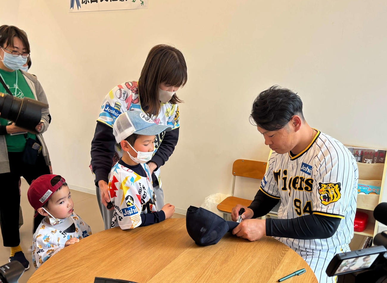 子どもが持参した帽子にサインを書く阪神原口（右）（撮影・塚本光）