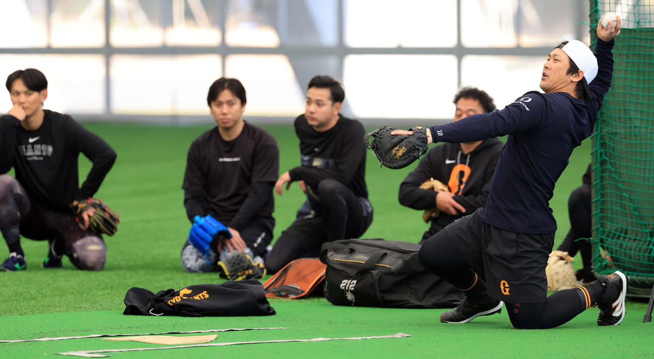 合同自主トレで、投手陣に見つめられながらブルペンで受ける巨人甲斐（右）（撮影・浅見桂子）