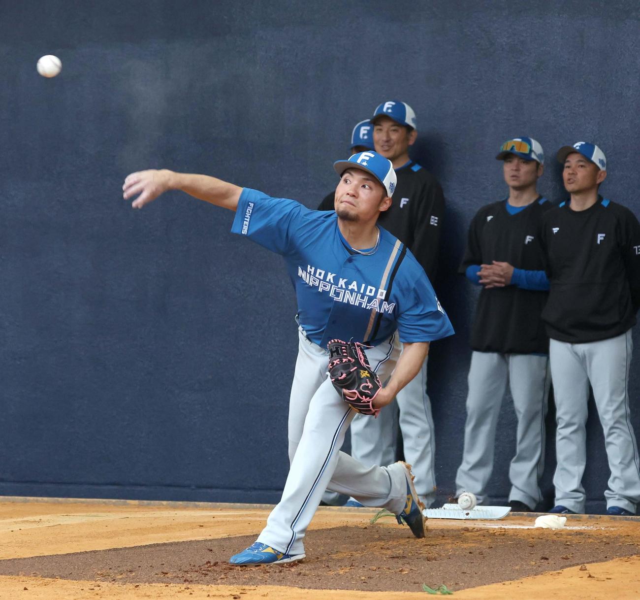 ブルペンで投球する日本ハム伊藤大海。後方左から2人目は加藤投手コーチ（撮影・黒川智章）
