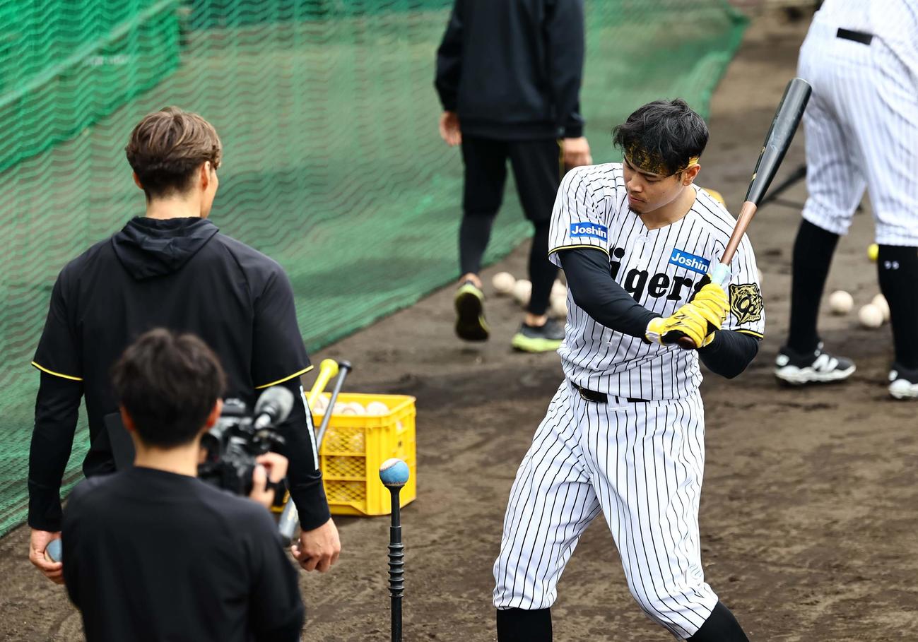 糸井嘉男臨時コーチ（左）の指導を受ける佐藤輝は色の付いたボールを打つ（撮影・上田博志）