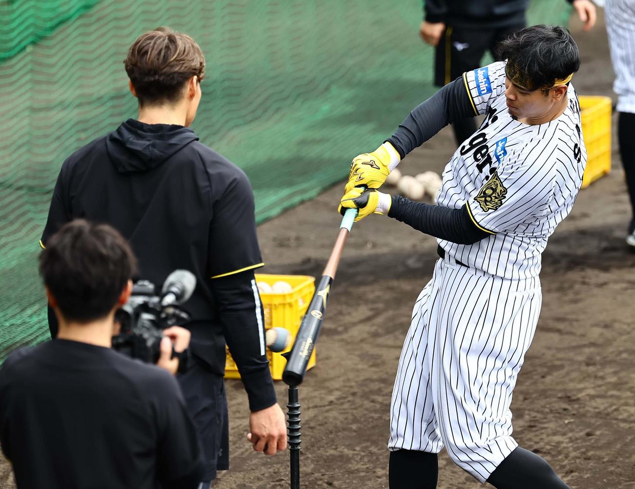 糸井嘉男臨時コーチ（左）の指導を受ける佐藤輝は色の付いたボールを打つ（撮影・上田博志）