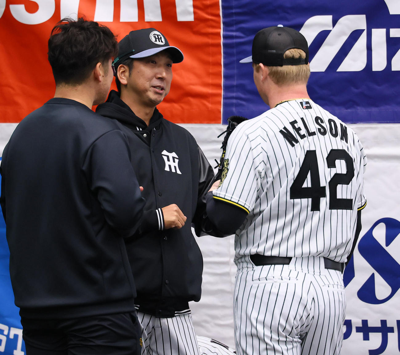ブルペン投球を終えたネルソンと話しをする藤川監督（左から2人目）（撮影・藤尾明華）
