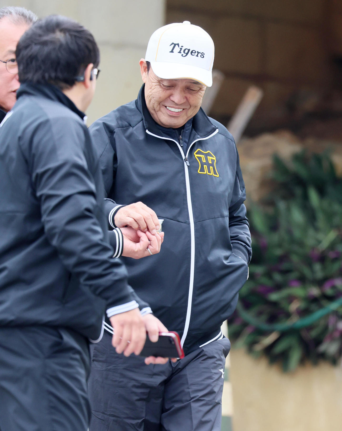 あめを手にする岡田オーナー付顧問（撮影・加藤哉）