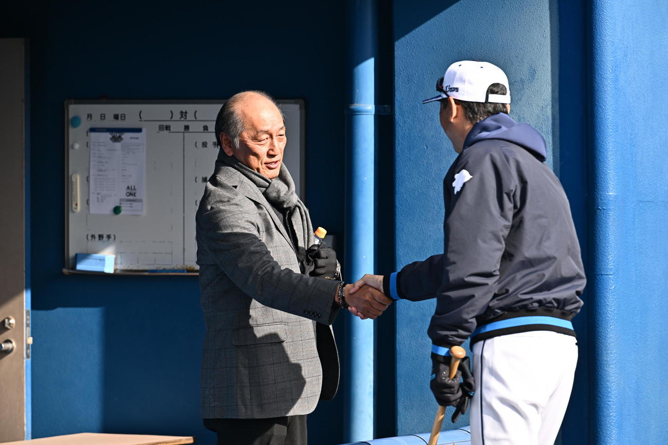 視察に訪れた渡辺氏（左）は西武西口監督と握手を交わす（撮影・滝沢徹郎）