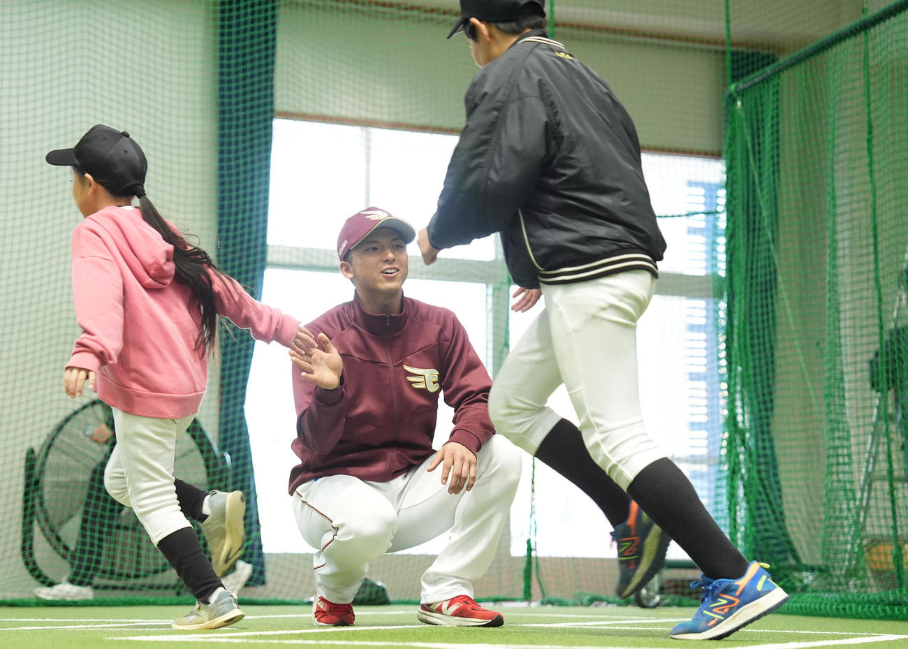 ふれあいイベントで、ベースランニングする子供たちとハイタッチする楽天宗山（撮影・鈴木みどり）