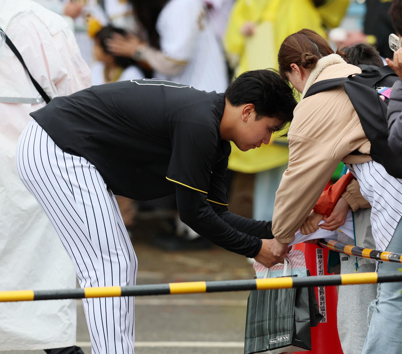 雨の中を待つファンにサインする門別（撮影・加藤哉）