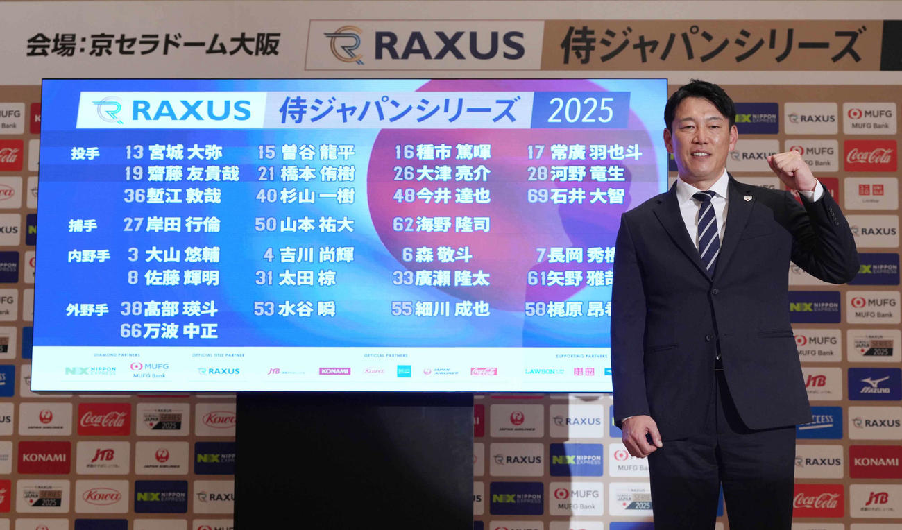 「ラグザス侍ジャパンシリーズ2025」出場選手発表記者会見で全メンバーが映された画面を背にガッツポーズする侍ジャパン井端監督（撮影・小沢裕）