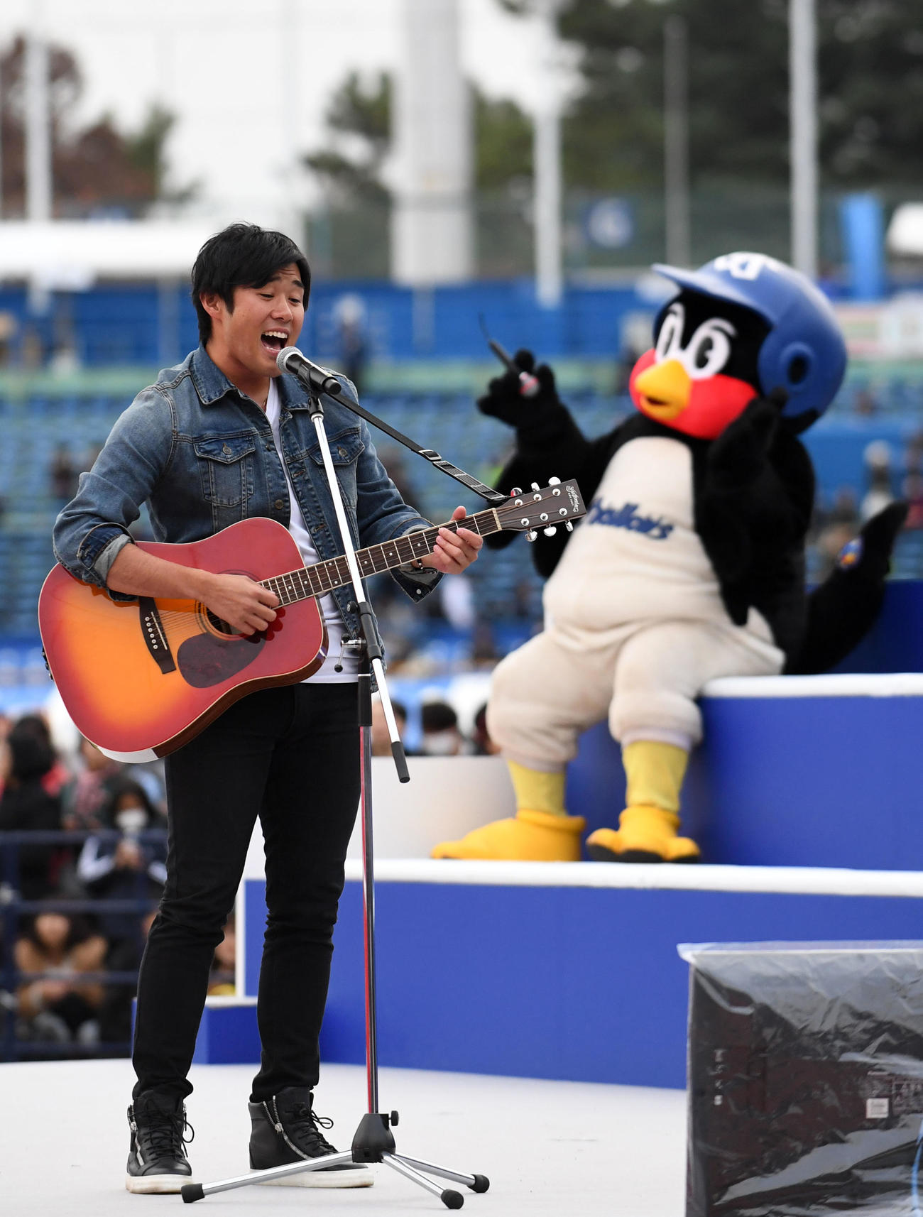 のど自慢合戦で美声を披露する由規。後方は歌を聴き入るつば九郎（撮影・横山健太）