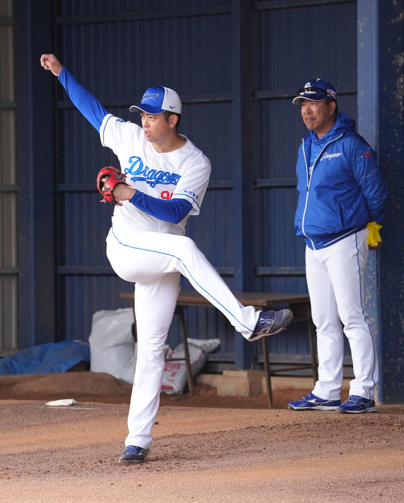 ブルペンで投球練習をする松山（左）右は井上監督（撮影・森本幸一）