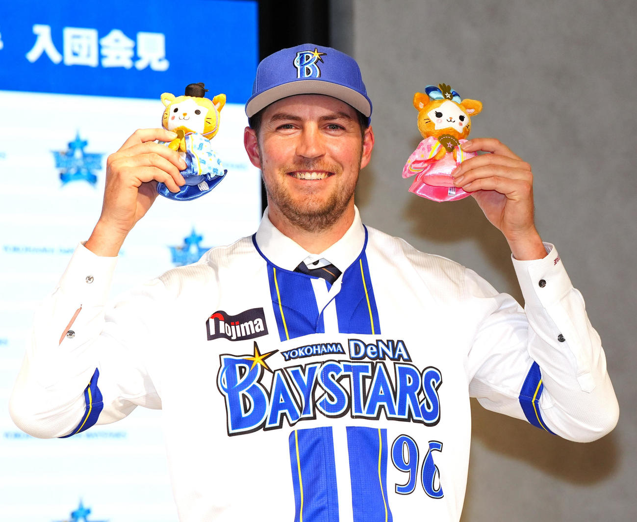 入団会見に臨み、ひな祭り使用のマスコット人形を手にするDeNAバウアー（撮影・江口和貴）