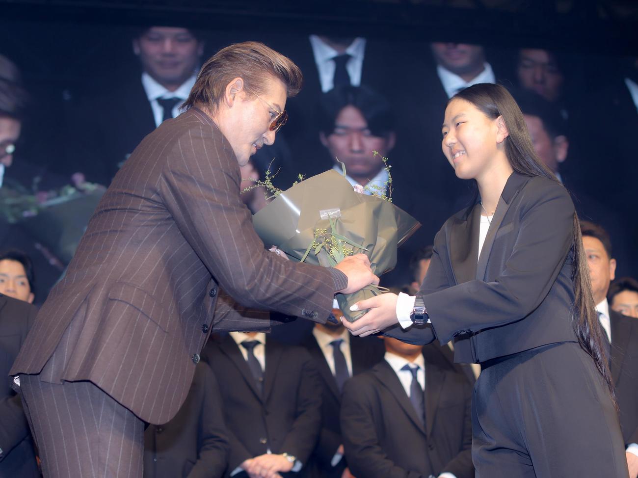 日本ハム新庄監督（左）に花束を贈呈する東京・パリ五輪スケートボード女子パーク銀メダリストの開（撮影・河田真司）