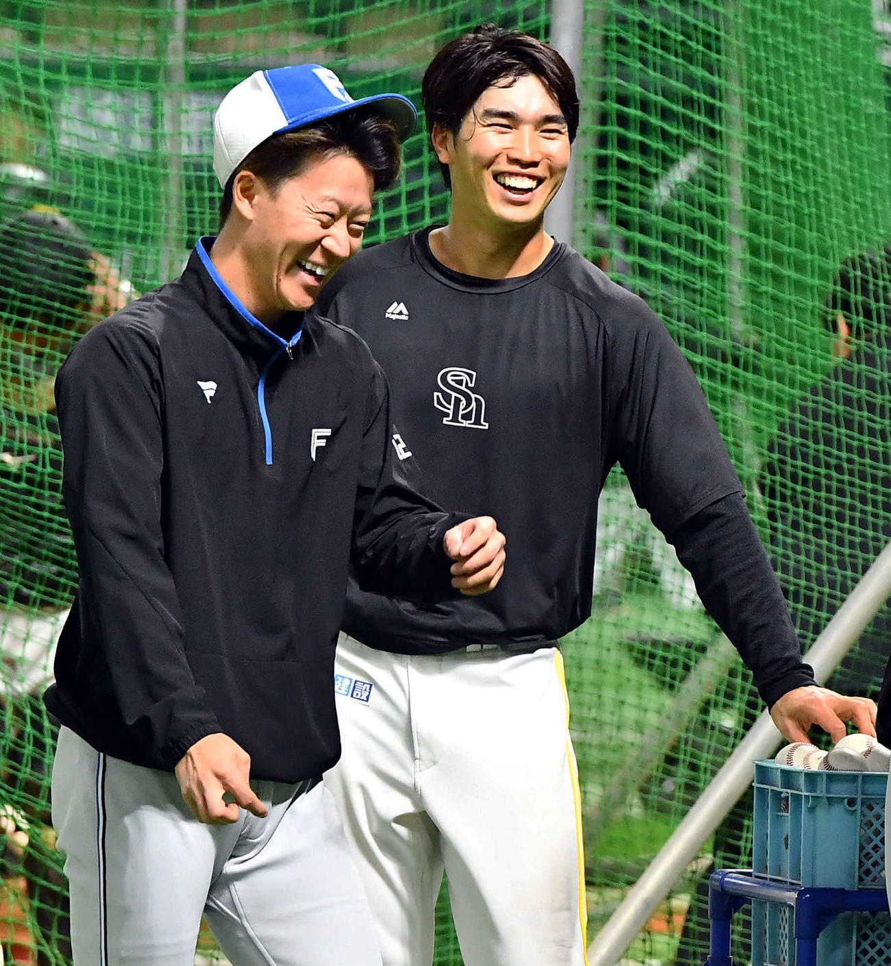 ソフトバンク対日本ハム　試合前、日本ハム矢沢（左）と談笑するソフトバンク広瀬隆（撮影・岩下翔太）