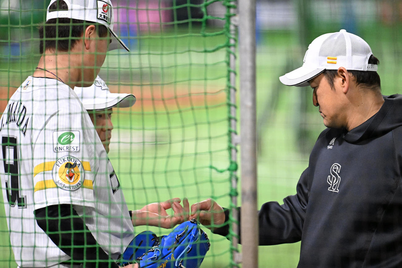 前田純（左）の指を確認する倉野コーチ（撮影・林敢治）