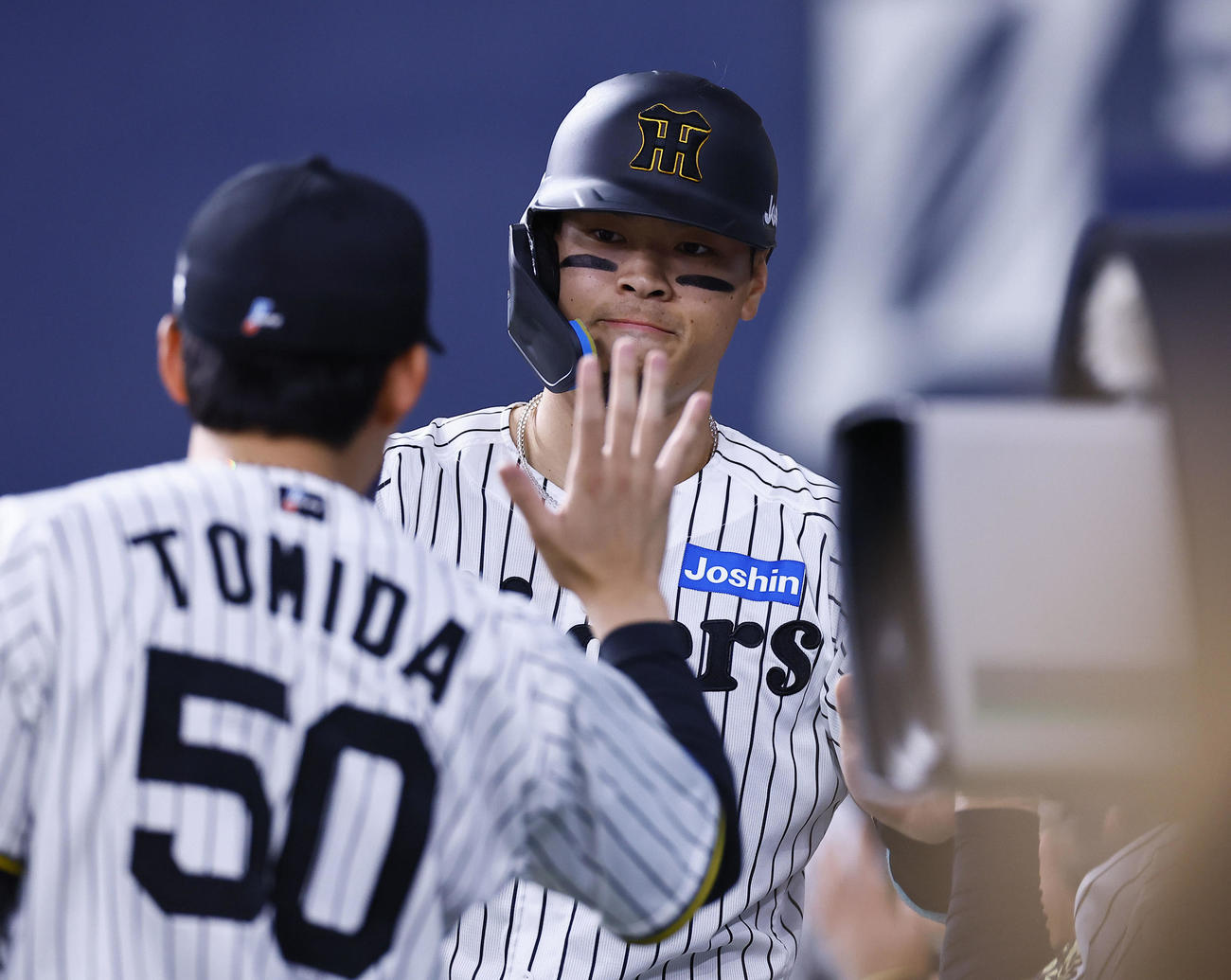 オリックス対阪神　2回裏阪神2死二、三塁、大山の2点適時二塁打で生還し、富田とタッチを交わす佐藤輝（撮影・藤尾明華）