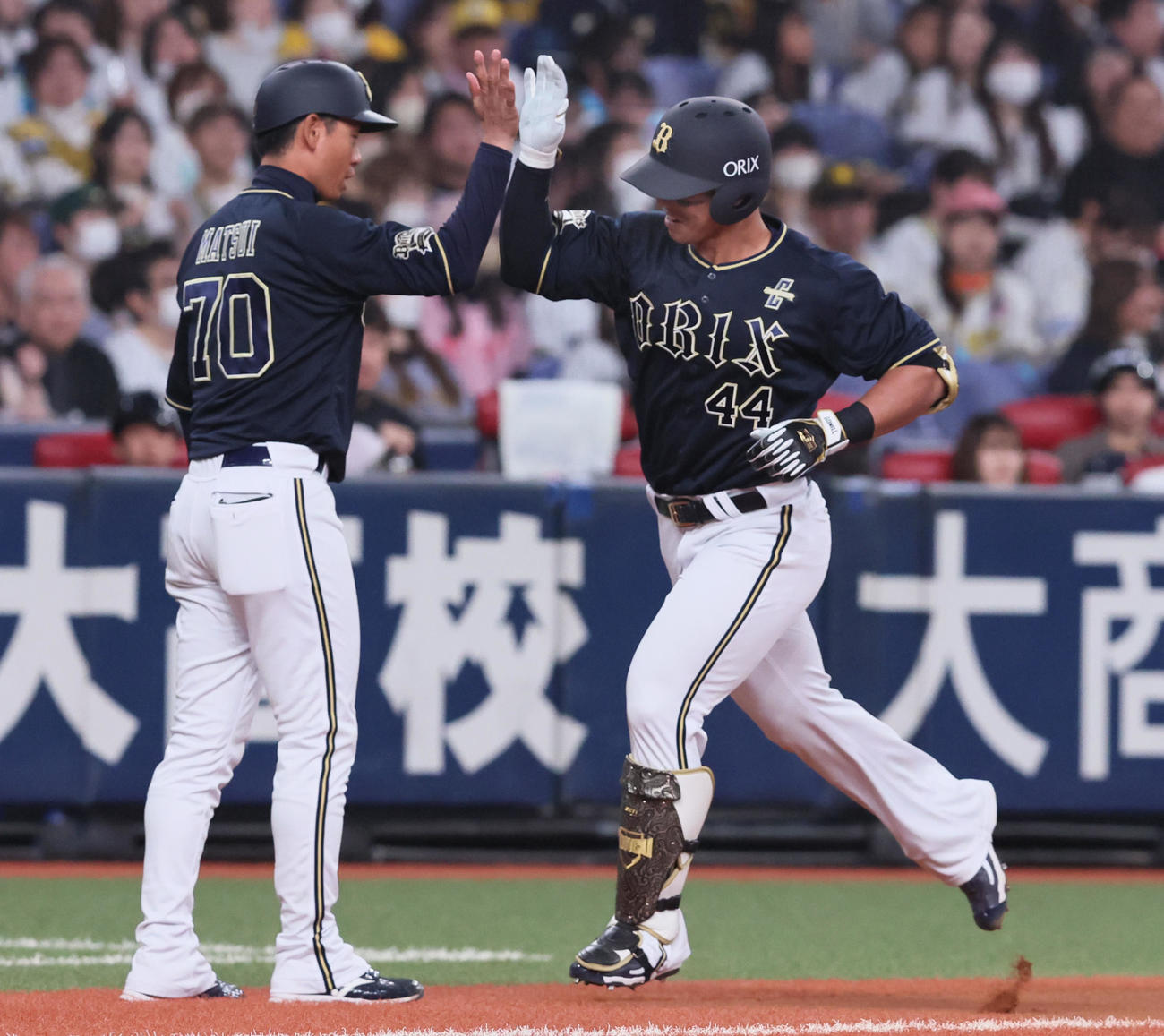 阪神対オリックス　4回表オリックス1死、頓宮は左越えソロ本塁打を放ち松井三塁コーチ（左）とタッチ（撮影・加藤哉）