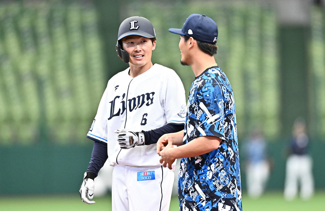 西武対DeNA　試合前練習で談笑する西武源田（左）と牧野（撮影・滝沢徹郎）