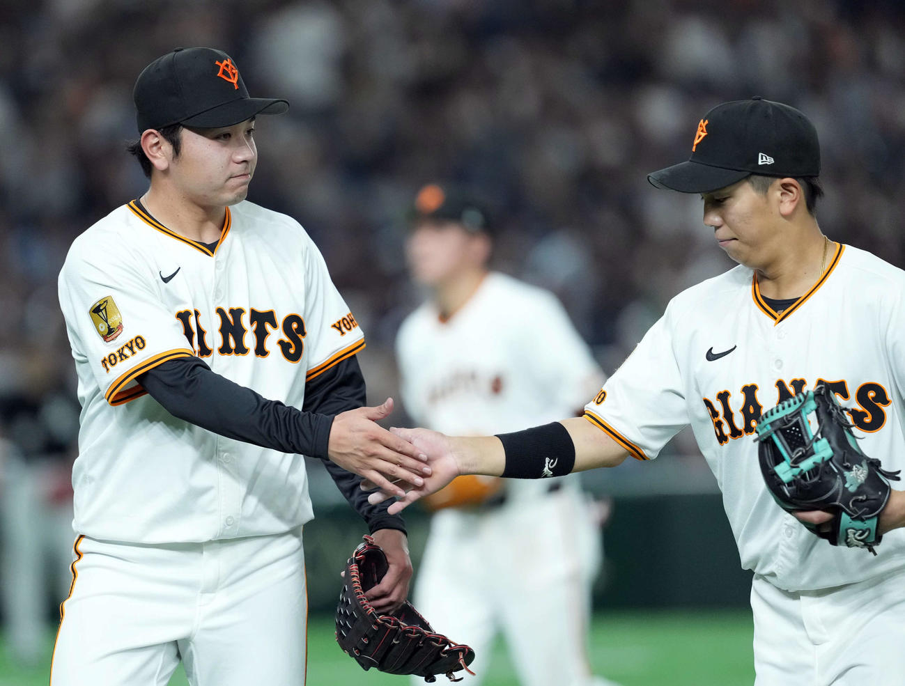巨人対ロッテ　4回表、無失点に抑え門脇とタッチする石川（撮影・たえ見朱実）