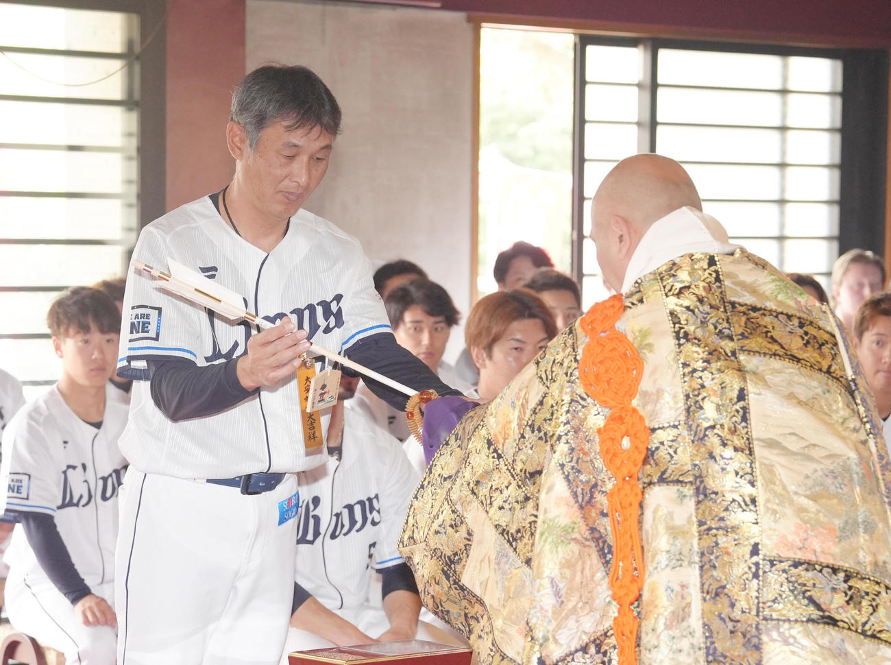 狭山山不動寺で必勝祈願を行い、矢を受け取る西武西口監督（撮影・足立雅史）