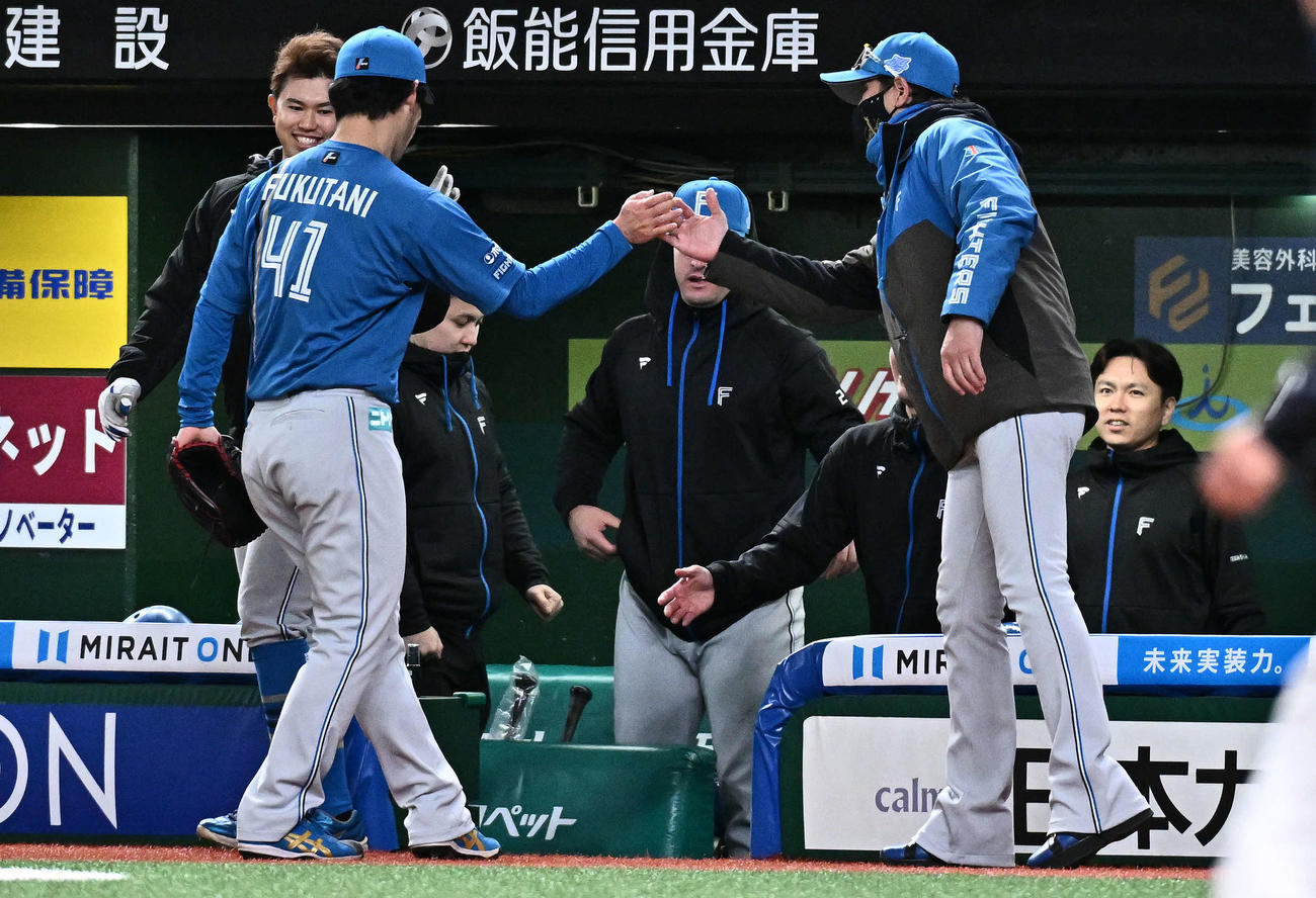 西武対日本ハム　9回裏を投げ終えた日本ハム福谷（左手前）とタッチをかわす新庄監督（撮影・滝沢徹郎）