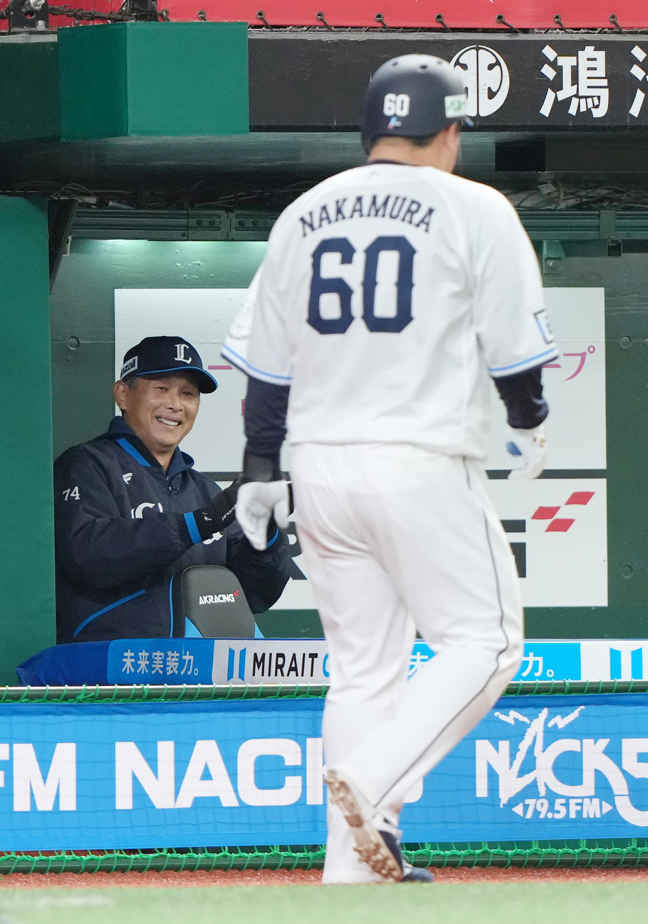 西武対日本ハム　8回裏西武1死一塁、右前打を放った中村剛（右）に笑顔を見せる西口監督（撮影・足立雅史）