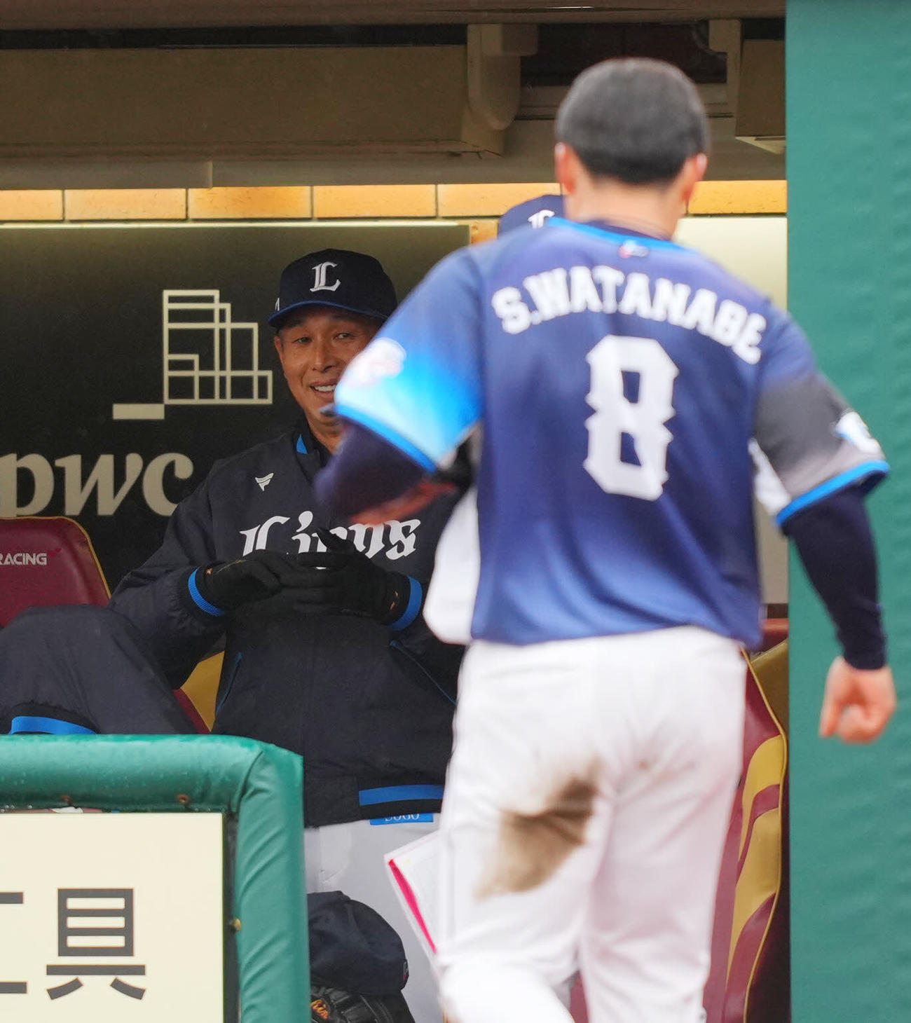 楽天対西武　4回表の攻撃を終え先制適時三塁打を放った西武渡部（手前）を笑顔で見つめる西口監督（撮影・垰建太）