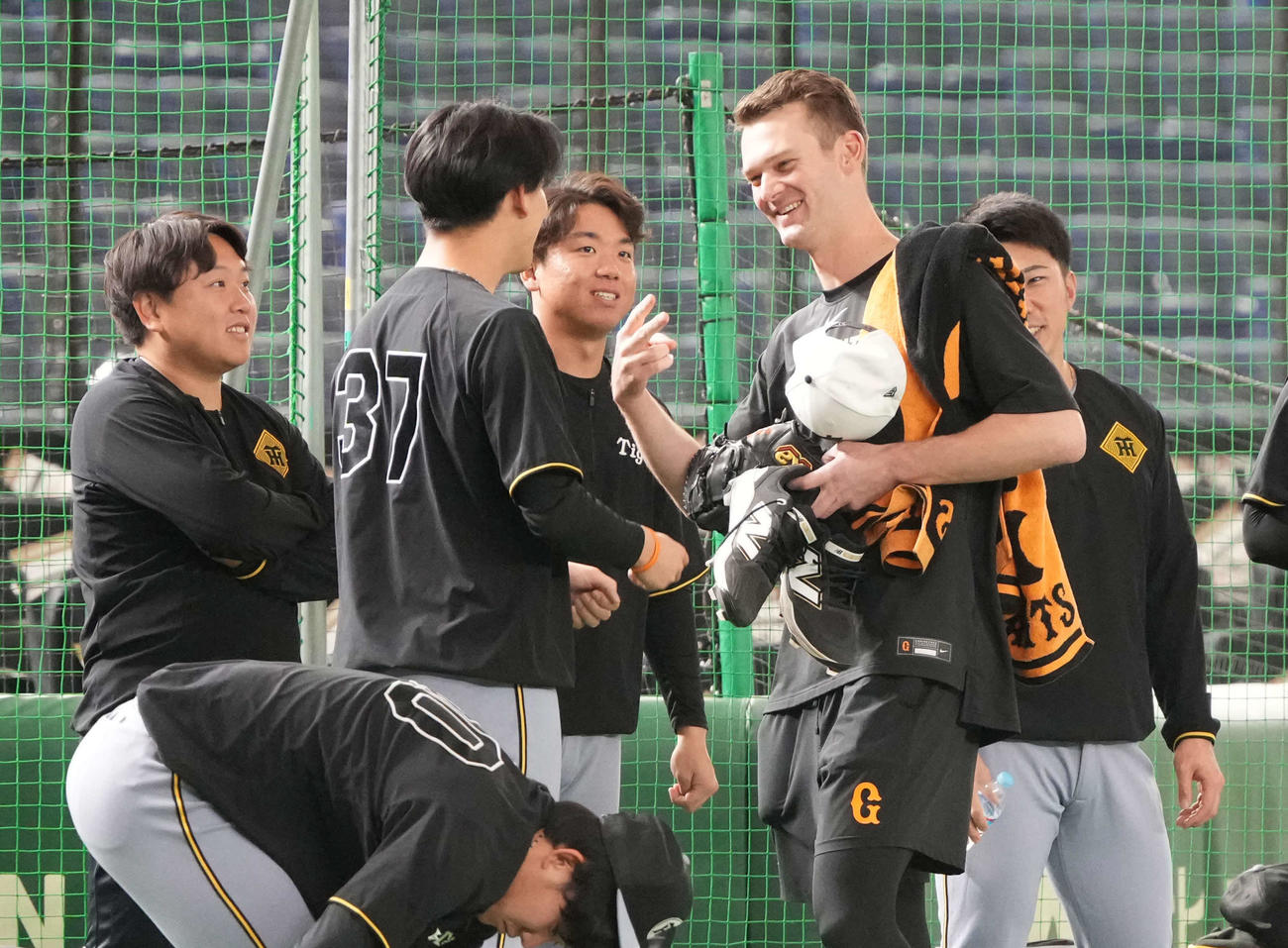 巨人対阪神　先発の村上（左から3人目）ら阪神投手陣と旧交を温める巨人ケラー（撮影・小沢裕）