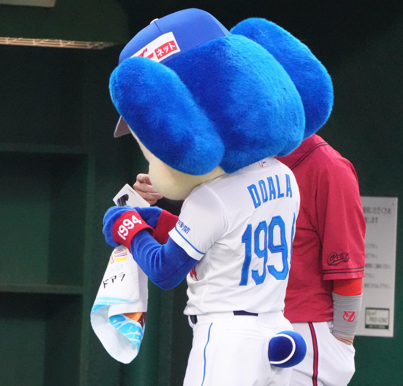 中日対広島　試合前、小園（左）からアイブラックのシールをもらうドアラ（撮影・森本幸一）