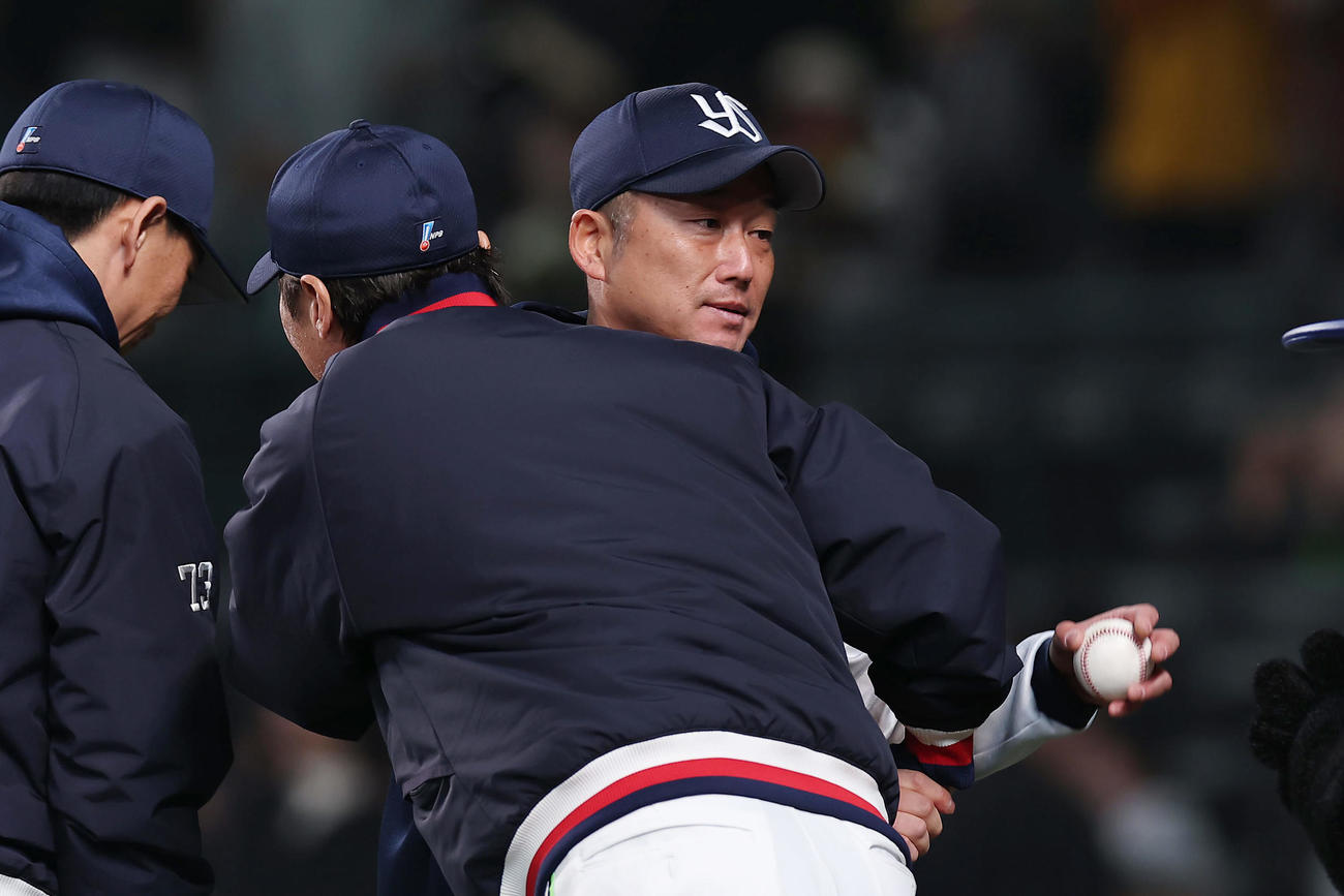阪神対ヤクルト　24年連続勝利を達成し、ヤクルト高津監督（手前）の祝福を受ける石川（撮影・前田充）