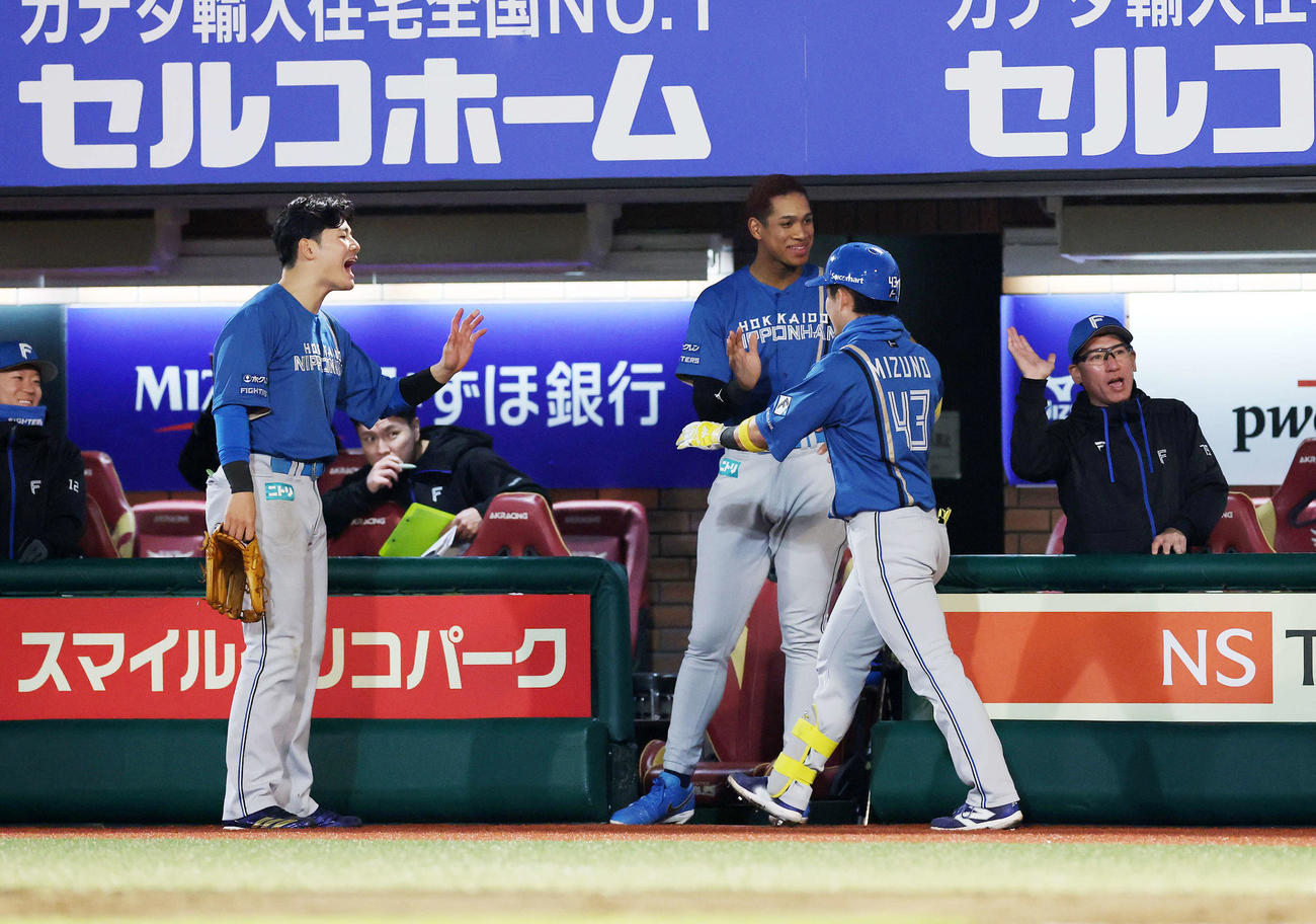楽天対日本ハム　3回表日本ハム2死一、二塁、水野（手前）の右越え3点本塁打を迎える選手たち（撮影・鈴木正人）　