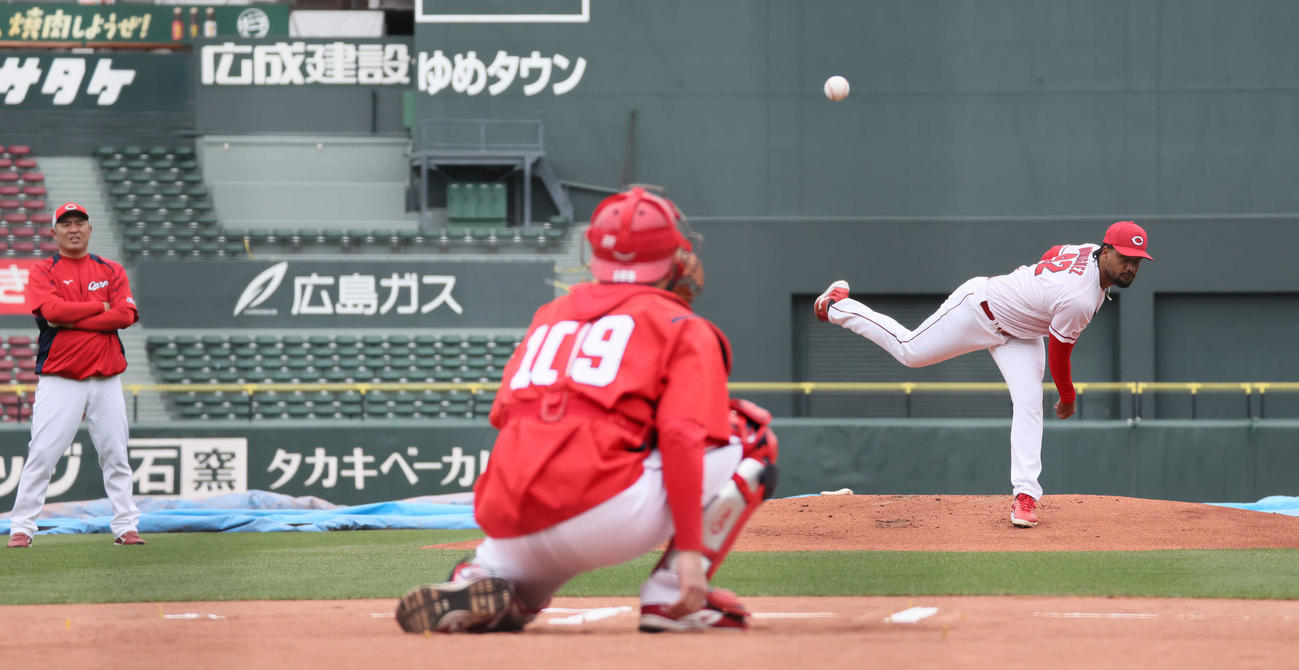 菊地原投手コーチ（左）が見守る中、マウンドで投球練習するドミンゲス（撮影・加藤孝規）