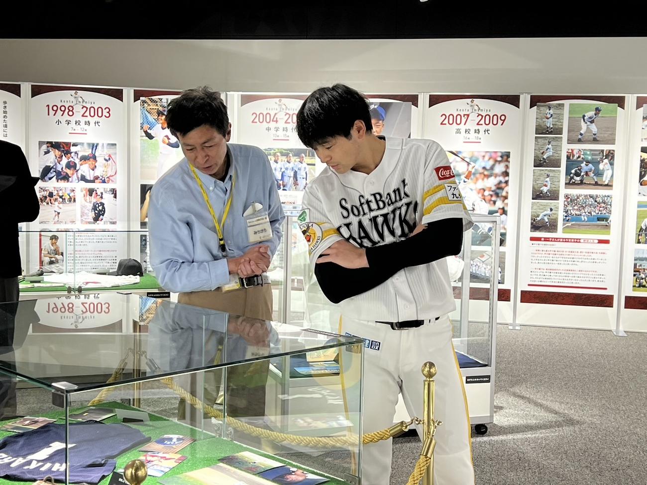 館内に展示された幼少期の写真や使用したユニホームを懐かしそうに内覧する川瀬（撮影・梅根麻紀）