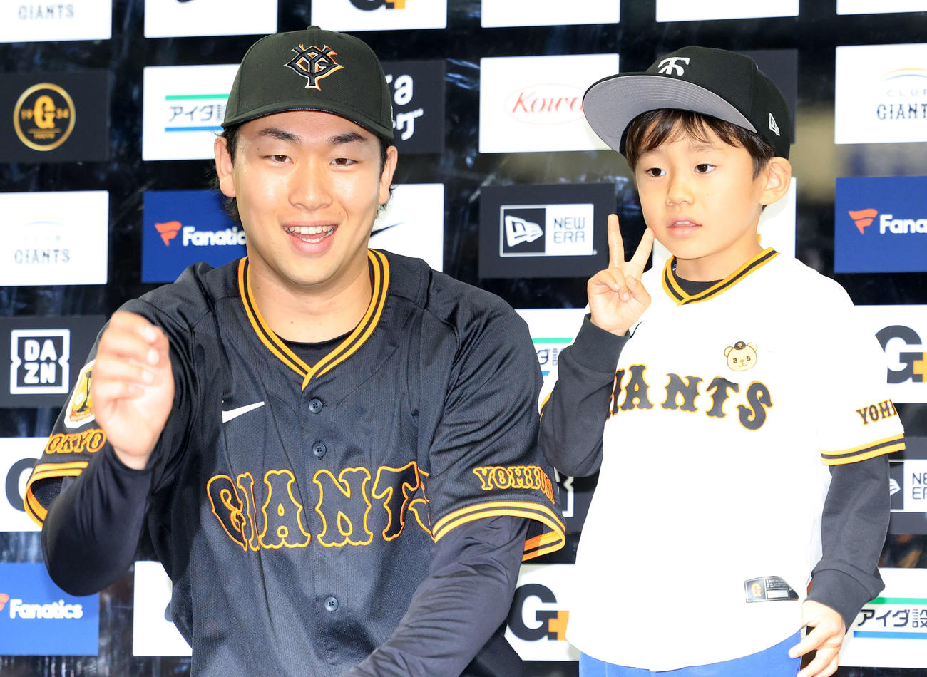 巨人対DeNA 3勝目を挙げ、ヒーローインタビューで子どもと笑顔で記念撮影する巨人山崎（撮影・浅見桂子）