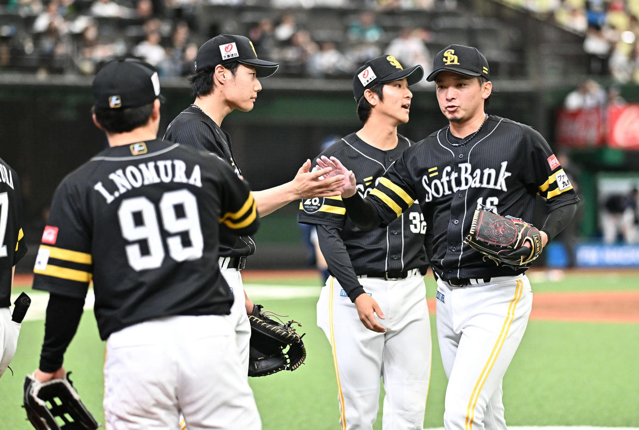 西武対ソフトバンク　5回裏を投げ終えチームメートとタッチをかわすソフトバンク先発の東浜（右）（撮影・滝沢徹郎）