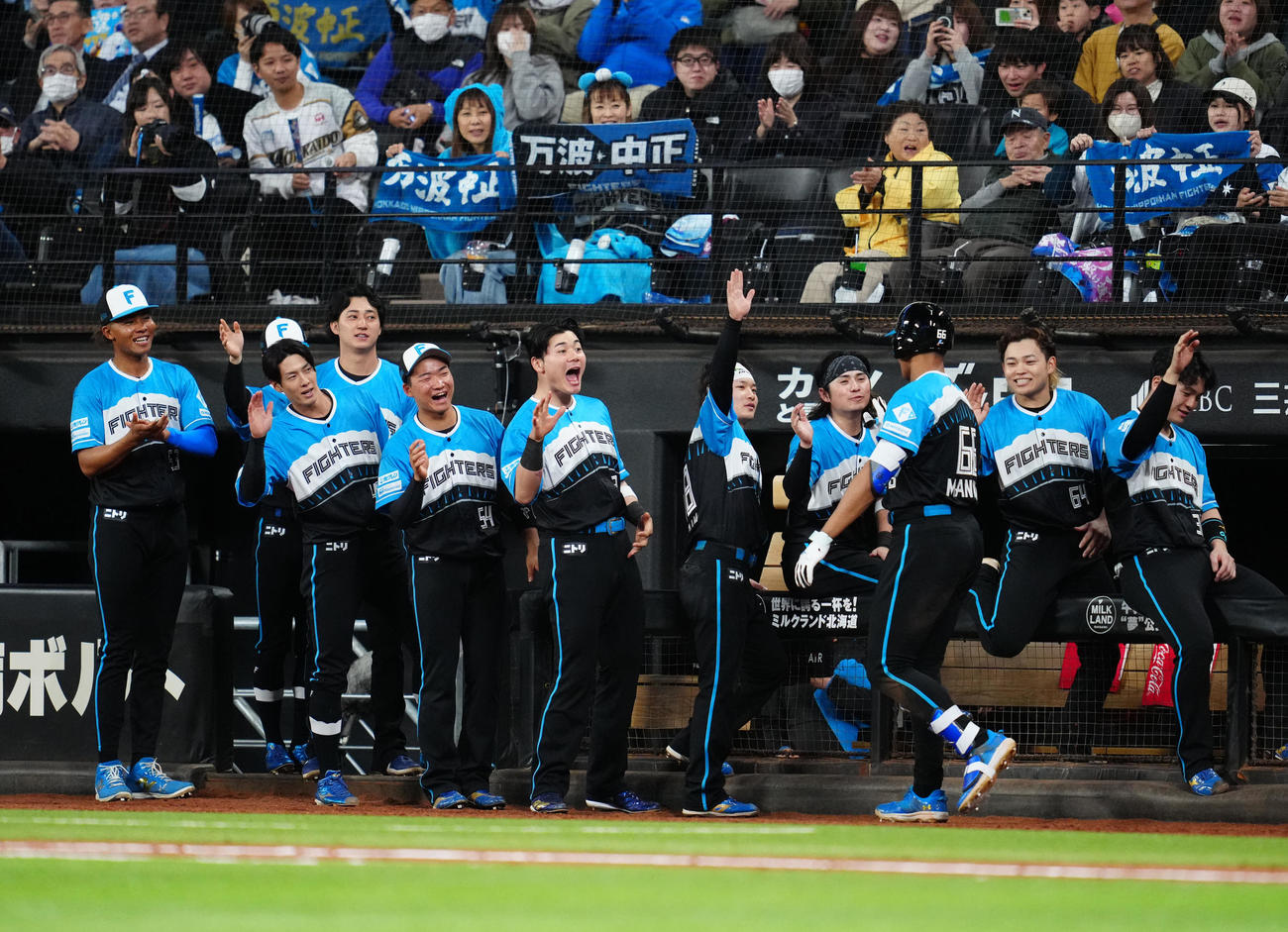 日本ハム対楽天　6回裏日本ハム無死、ソロ本塁打を放った万波（右から3人目）を迎える選手たち（撮影・江口和貴）