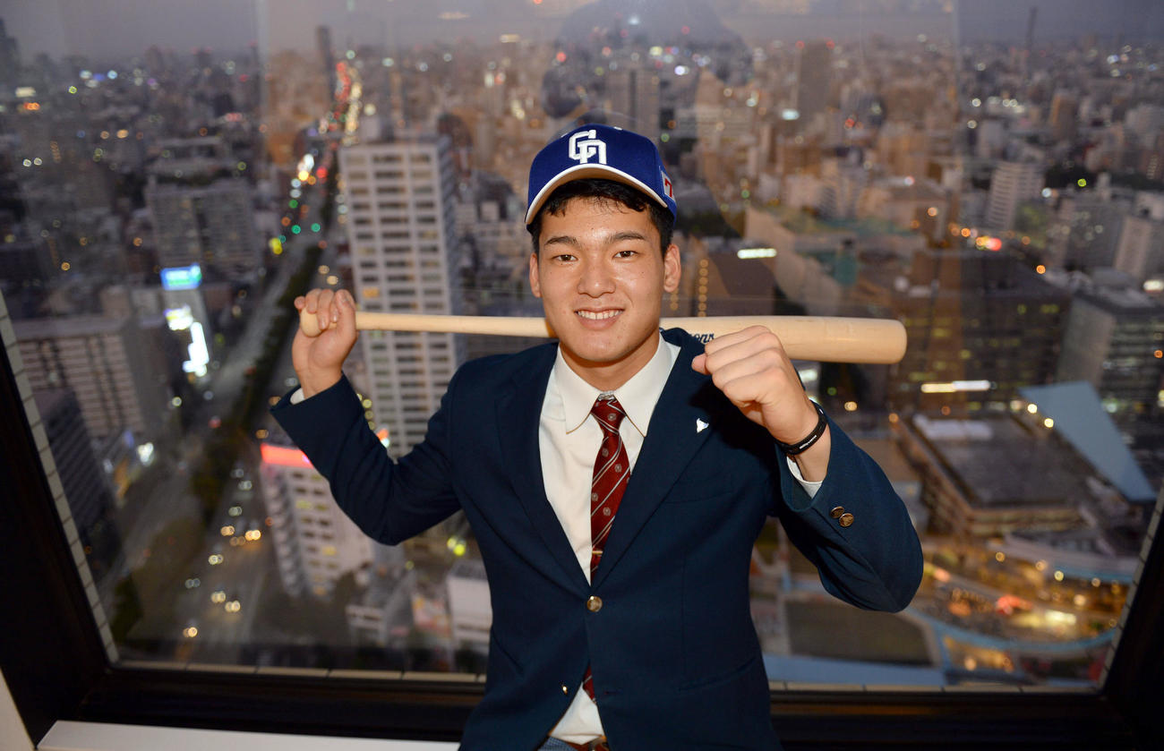 仮契約を終え、名古屋の街並みを背にバットを手に笑顔を見せる石川昂弥（2019年11月撮影）