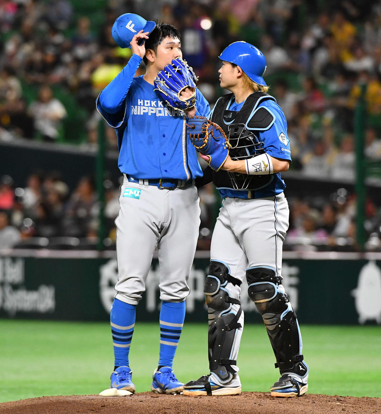 ソフトバンク対日本ハム　1回裏ソフトバンク2死二塁、中村に右前適時打を打たれ、マウンドで田宮（右）と話す古林睿煬（撮影・岩下翔太）