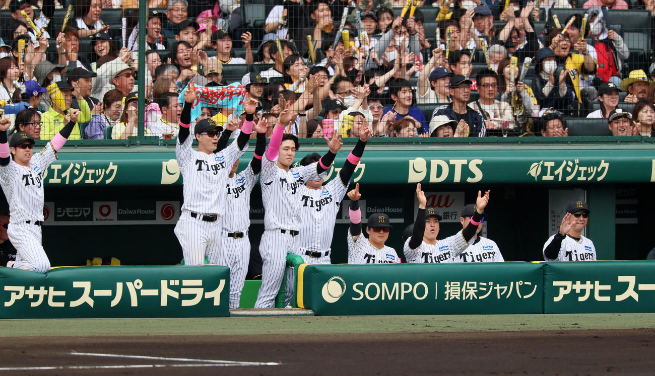 阪神対中日　1回裏阪神2死一塁、佐藤輝の右越え適時二塁打にベンチで喜ぶナイン。右端は藤川監督（撮影・加藤哉）
