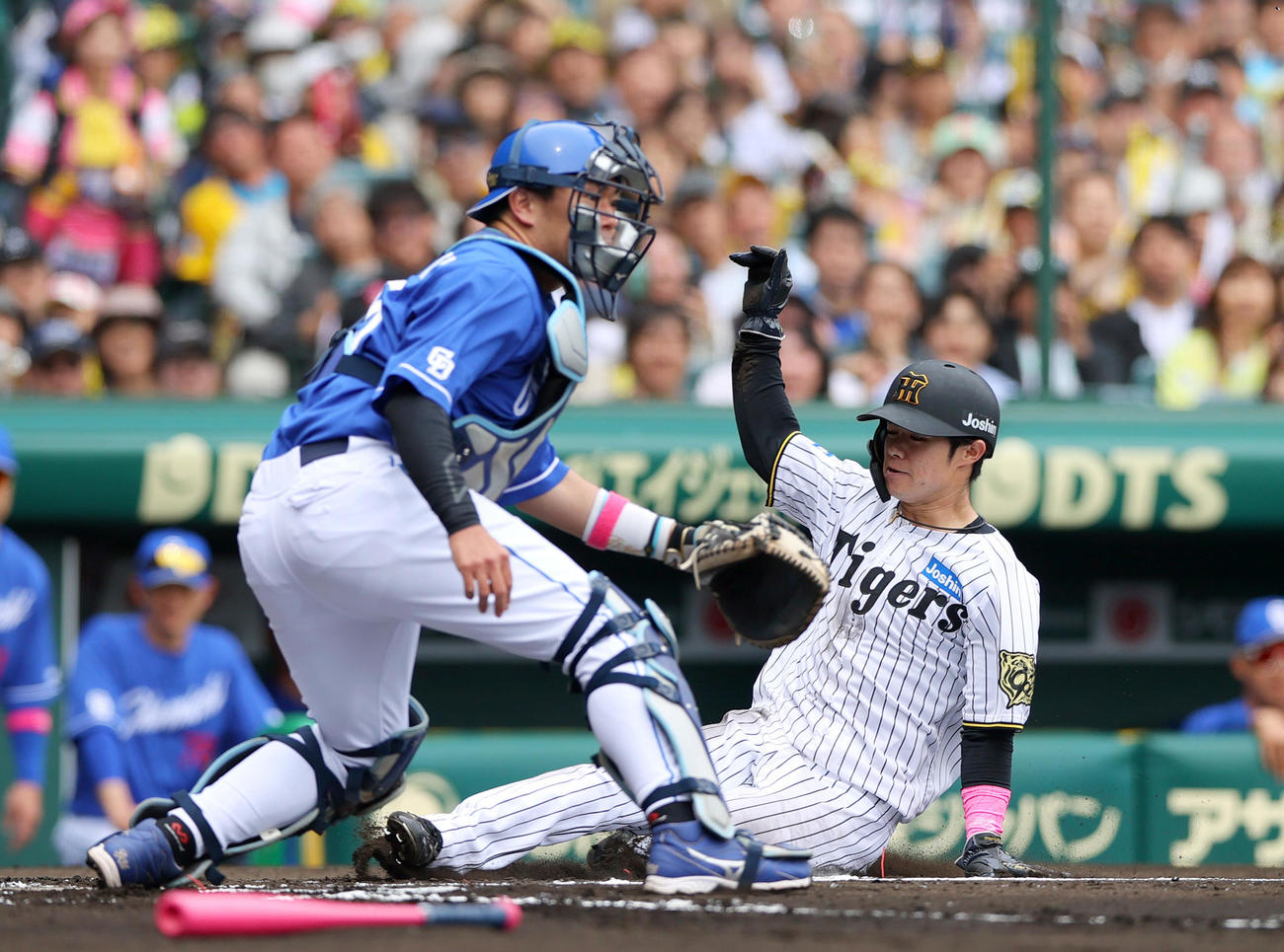 阪神対中日　1回裏阪神2死一塁、一走中野（右）は佐藤輝の右適時二塁打で生還する。捕手木下拓（撮影・上山淳一）