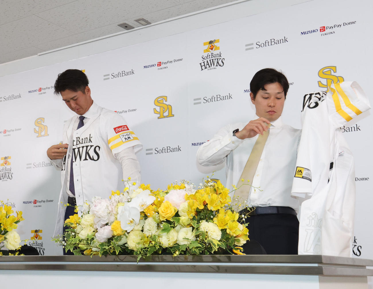 入団会見でユニホーム姿を披露する秋広（左）と大江（撮影・梅根麻紀）