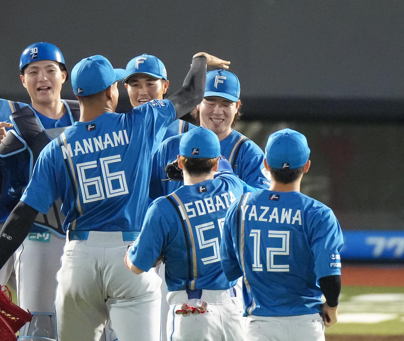 楽天対日本ハム　完封勝利を挙げた日本ハム金村（中央）は万波に頭をたたかれ祝福される（撮影・足立雅史）