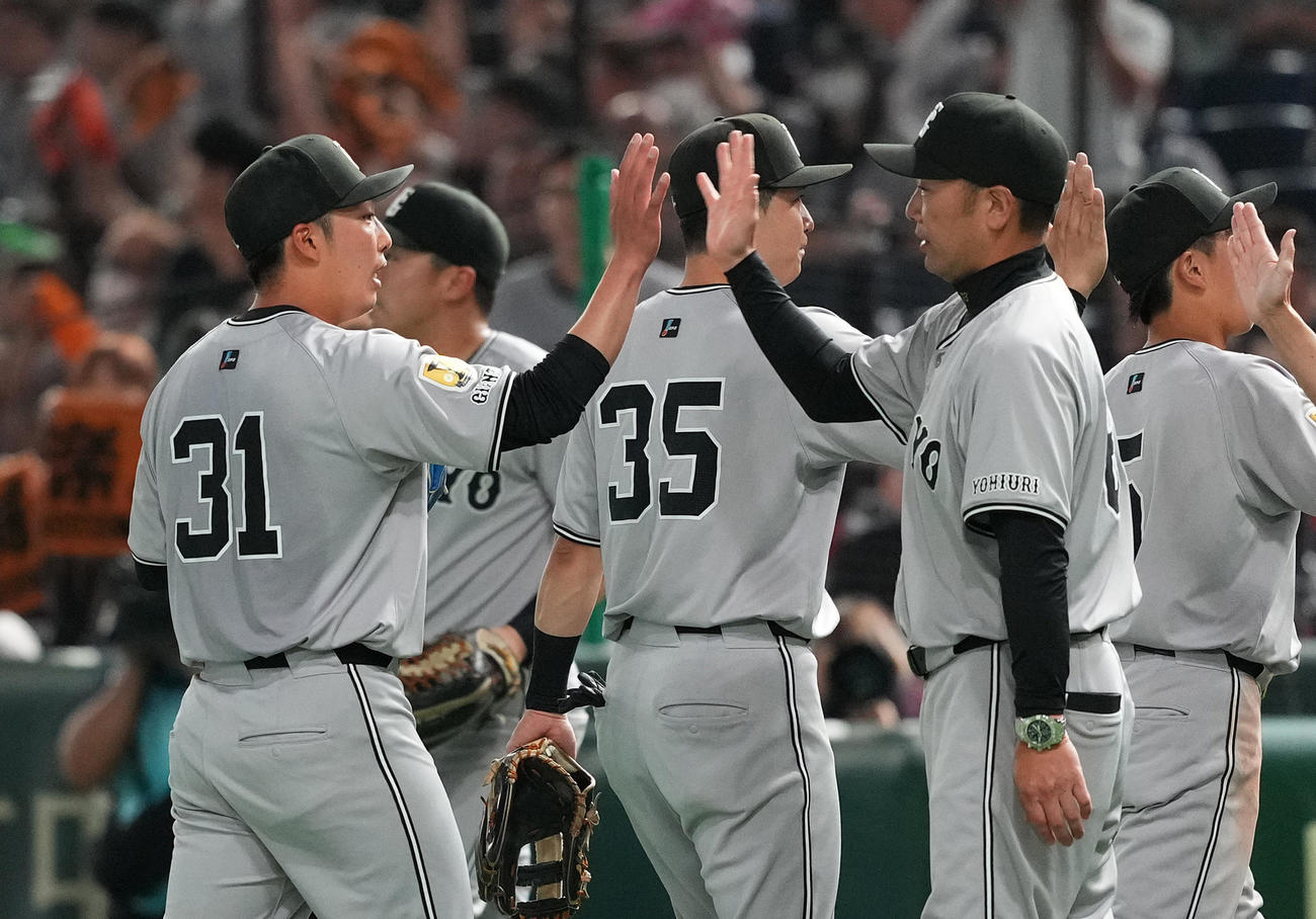 巨人対ヤクルト　完封勝利を飾り、阿部監督（右）にタッチで祝福される巨人赤星（撮影・菅敏）